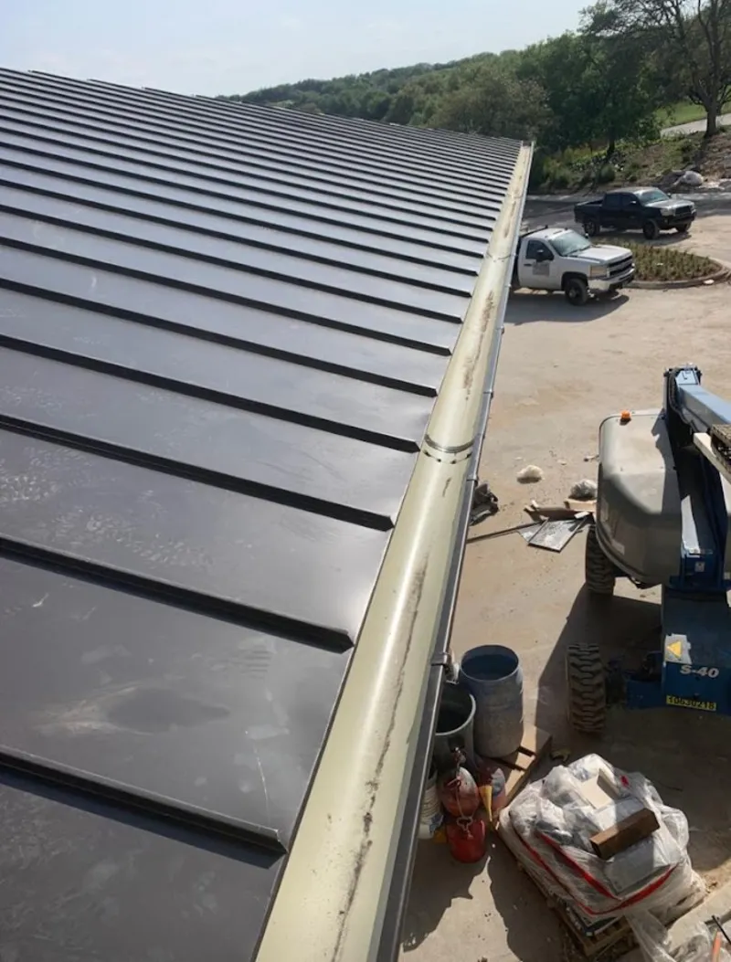 Standing seam panel and gutter detail on a metal roofing jobsite in Plattekill
